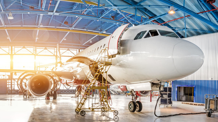 maintenance and repair of aircraft in the aviation hangar of the airport, view of a wide panorama.