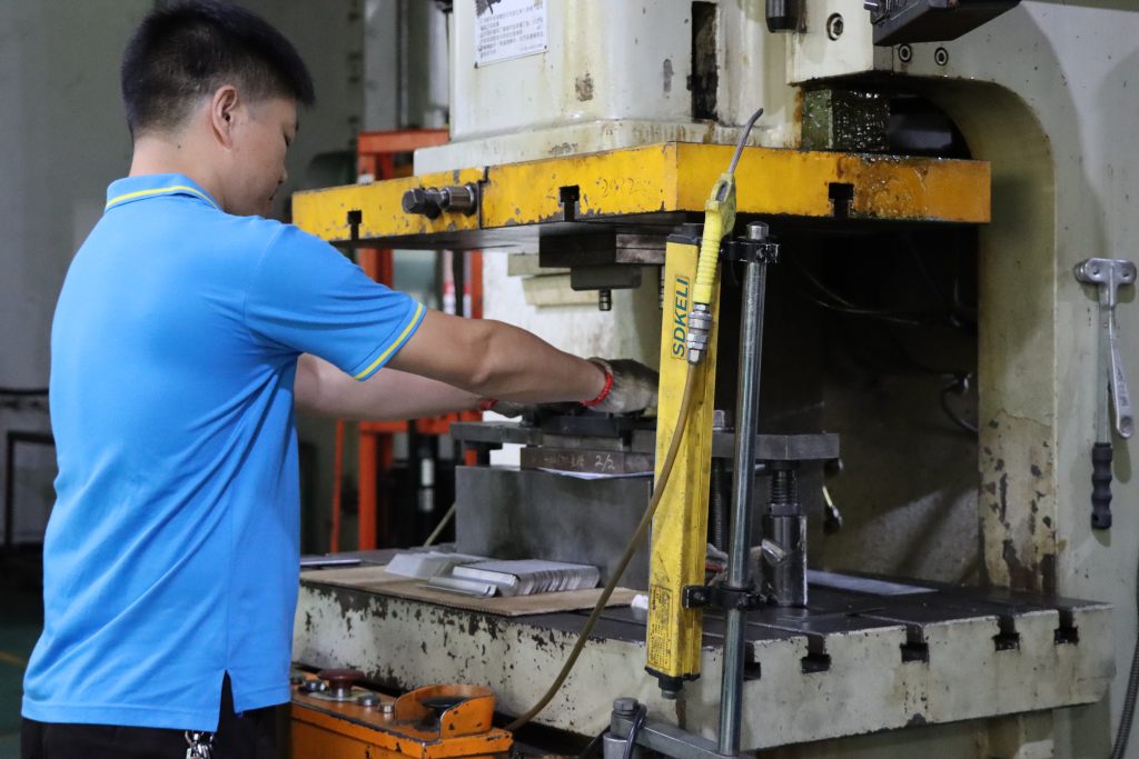 Workers are performing coining operations