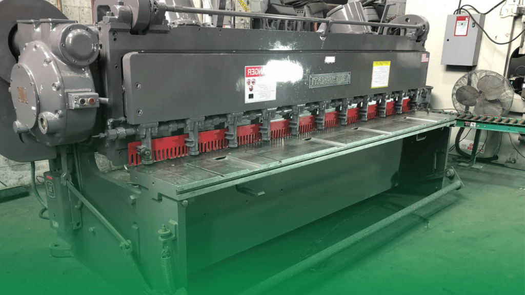 Shearing machine performing straight-line cuts on sheet metal for simple shapes.