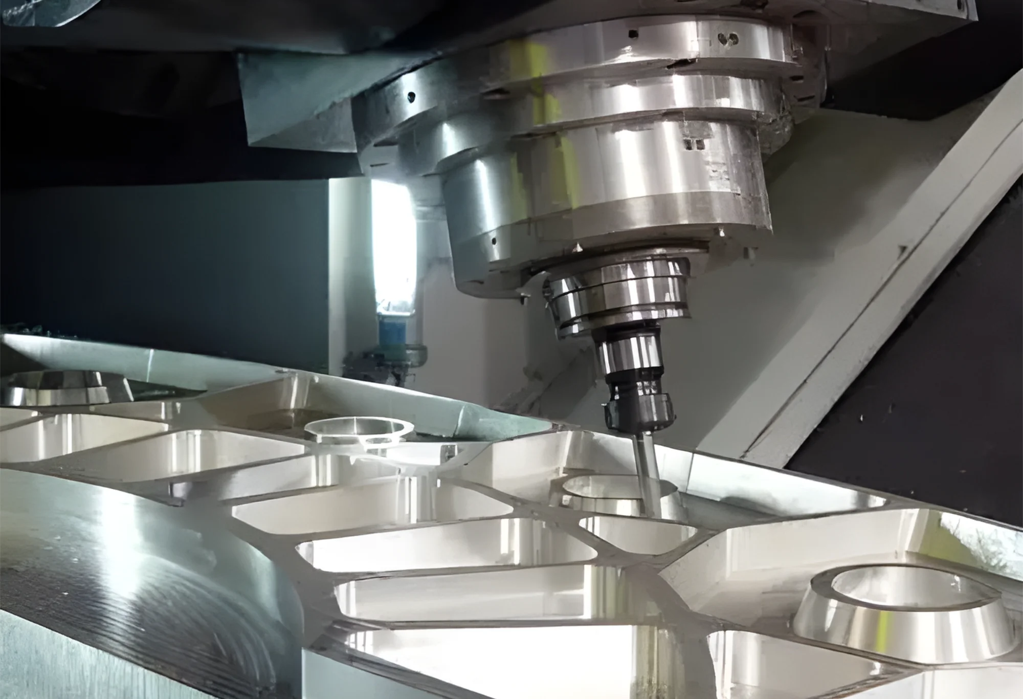 The machine is milling a large aluminum part for aerospace applications.